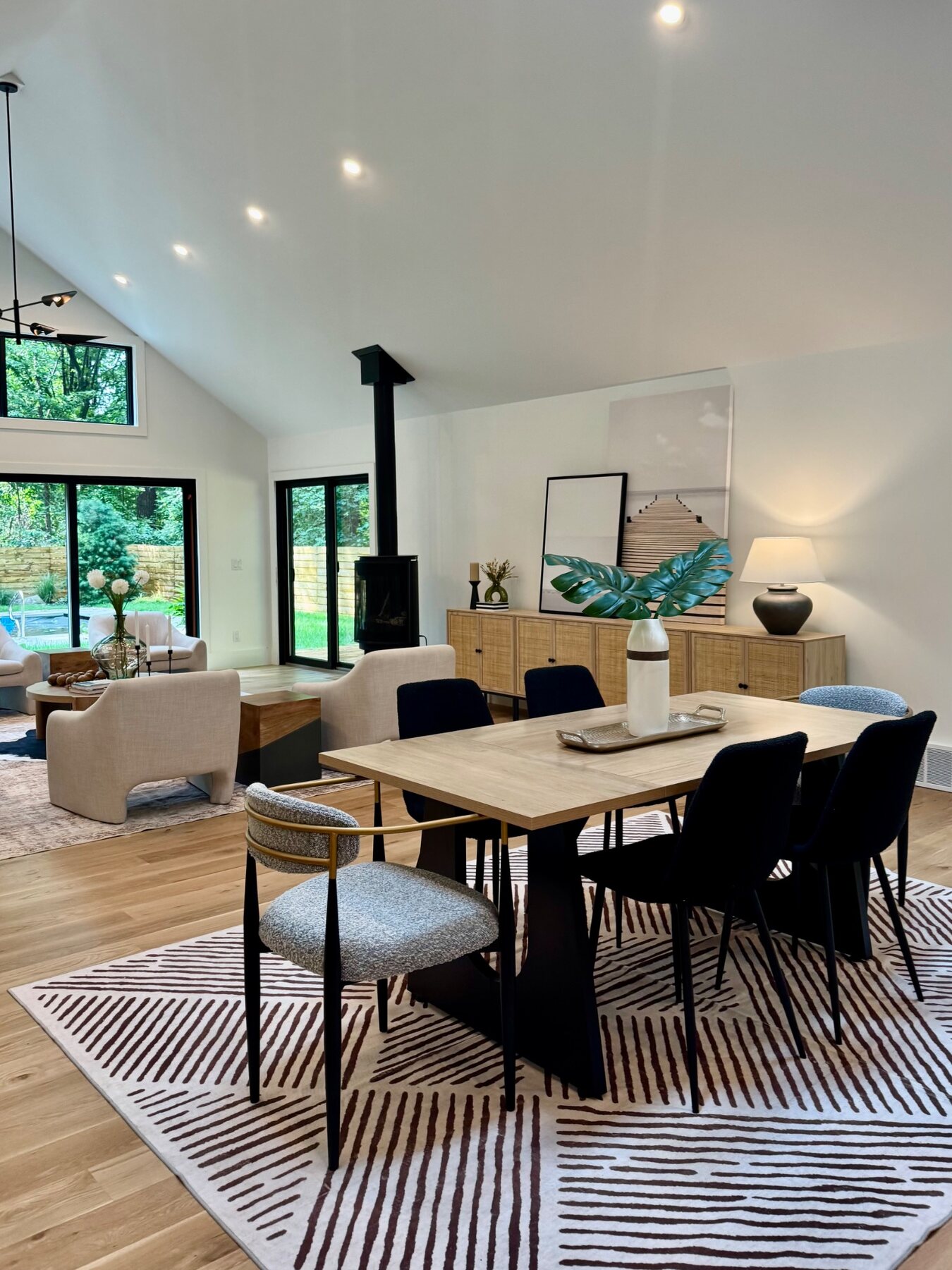 Modern open-plan living and dining room staged with natural wood and black accents